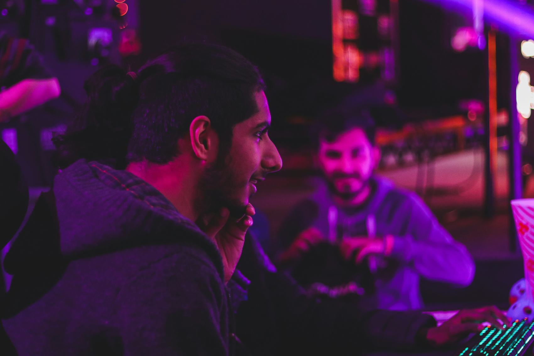 Two people working at a lit desk during an event